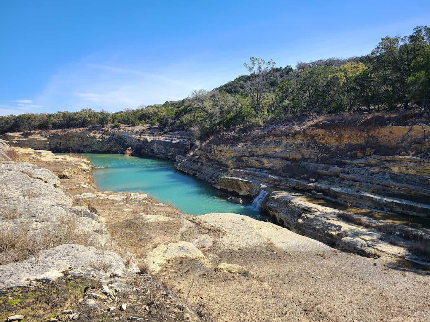 Turquoise pool cut through bare limestone in Canyon Lake Gorge
