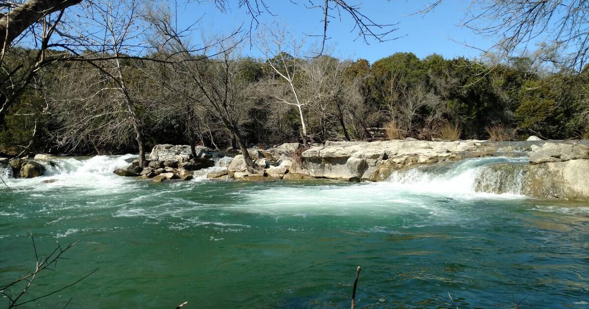 This Secret Central Texas Swimming Hole Has Two Waterfalls That Spill Into the Same Pool