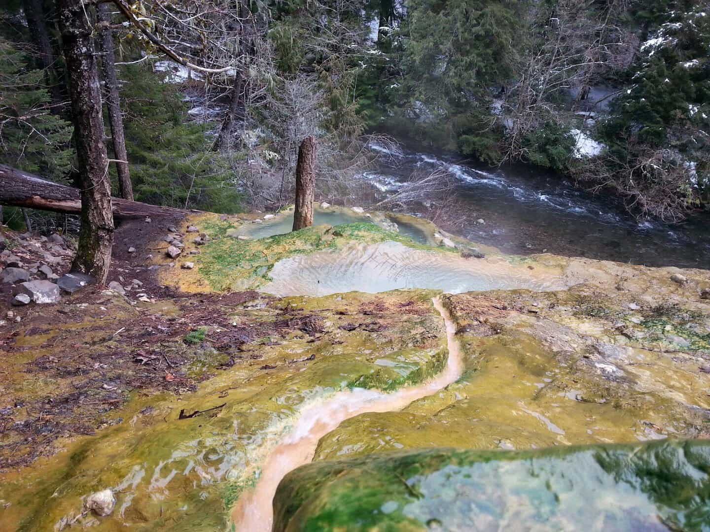 The terraced travertine soaking pools of Umpqua Hot Springs above the North Umpqua River in Oregon