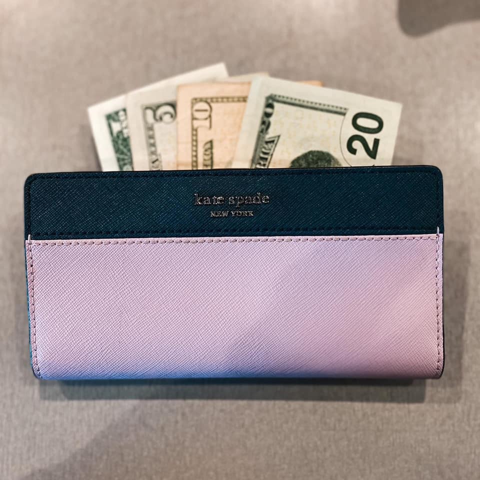 A designer wallet with cash at Uptown Cheapskate Tyler