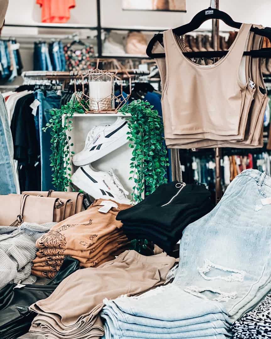 Denim and tops on organized racks at Uptown Cheapskate Tyler