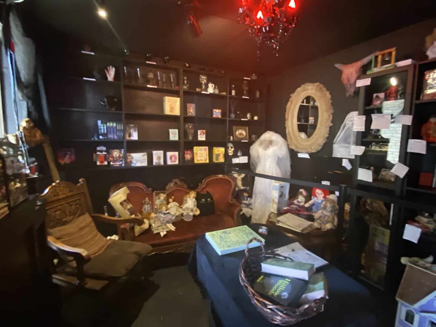 Victorian gothic sitting room with a velvet settee and curiosities at Triple Six Social in San Marcos, Texas