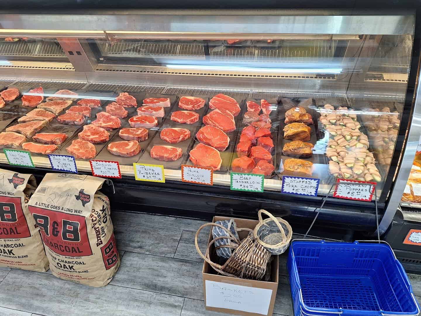 Meat market case of steaks and house-smoked sausage at Vincek's Smokehouse in East Bernard, Texas
