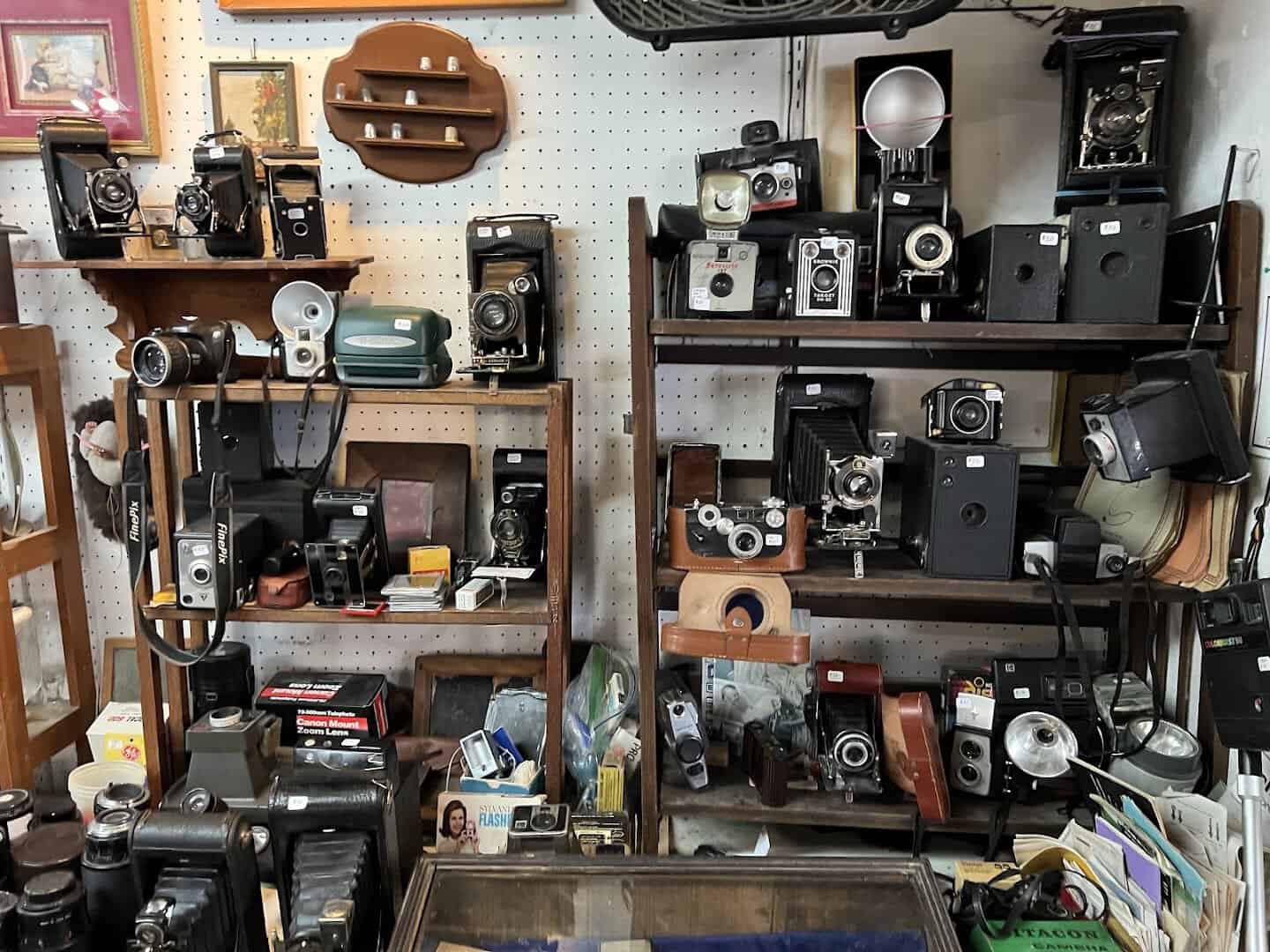 Shelf of vintage cameras and collectibles at Bussey's Flea Market in Schertz, Texas