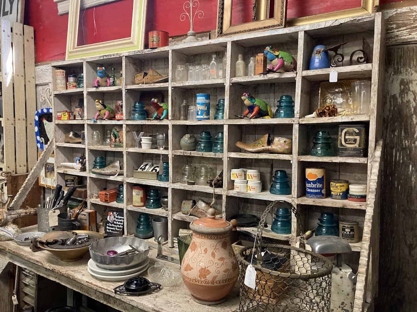 Shelves of vintage glass insulators, pottery and small treasures at Old Home Supply House in Fort Worth