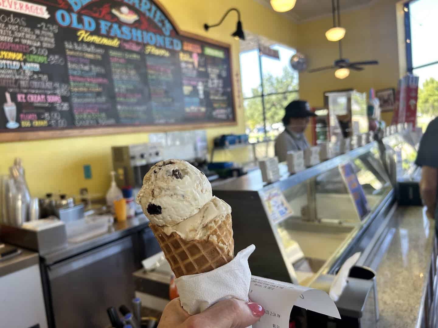 Scoop of ice cream in a waffle cone at the counter of Beth Marie's in Denton