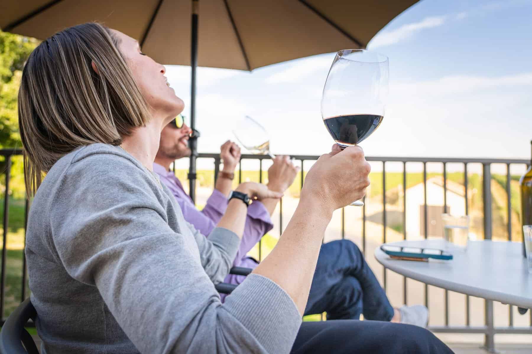 Friends toasting wine on the terrace at Pepper Bridge Winery in Walla Walla, Washington