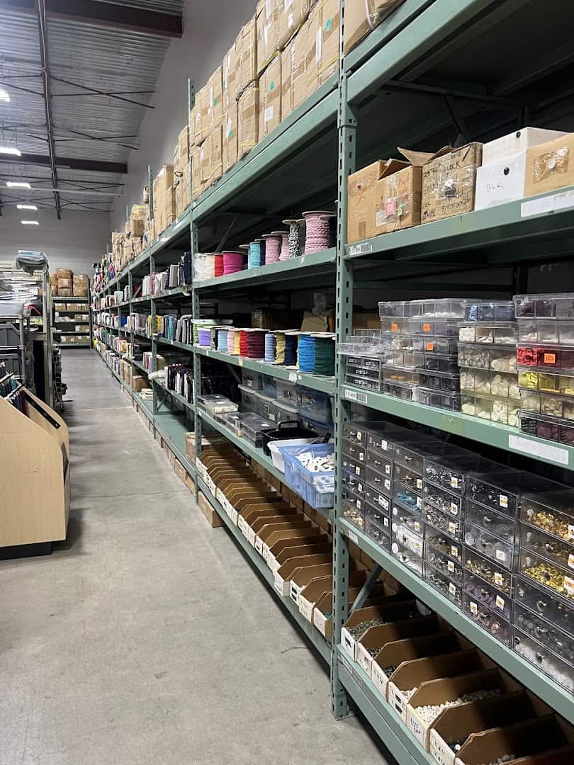 Warehouse aisle of shelving stacked with fabric at Wherehouse Fabrics in Dallas