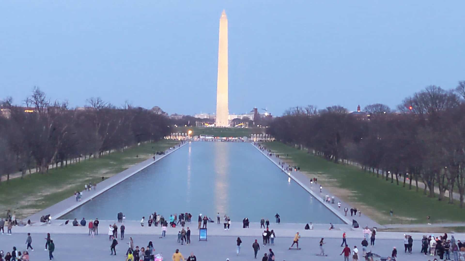 The Washington Monument glowing at twilight, mirrored in the reflecting pool, Washington, D.C.