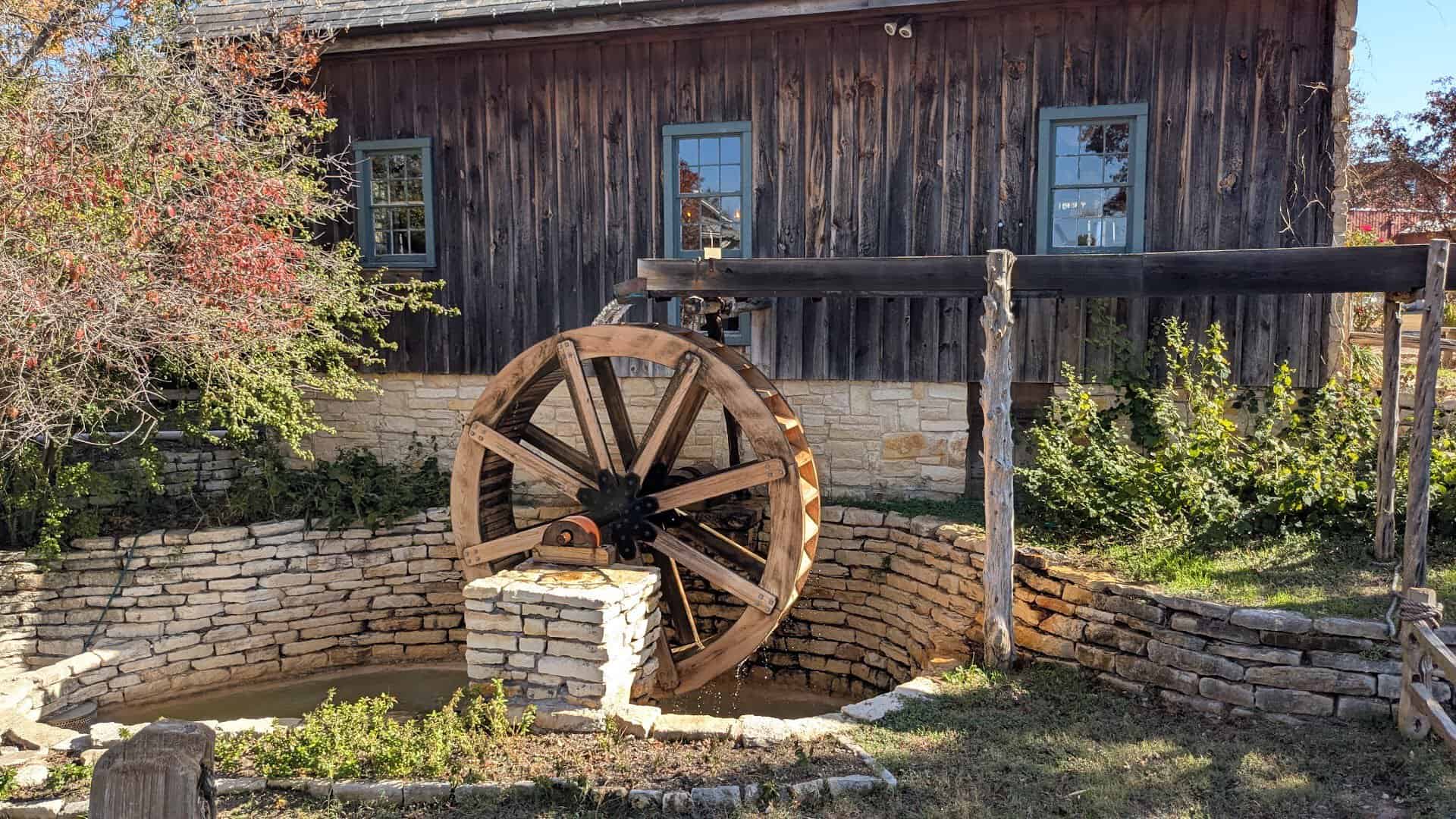 Water wheel on the restored gristmill at Homestead Heritage near Waco, Texas