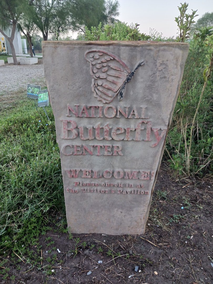 Stone welcome monument with a carved butterfly at the National Butterfly Center in Mission, Texas