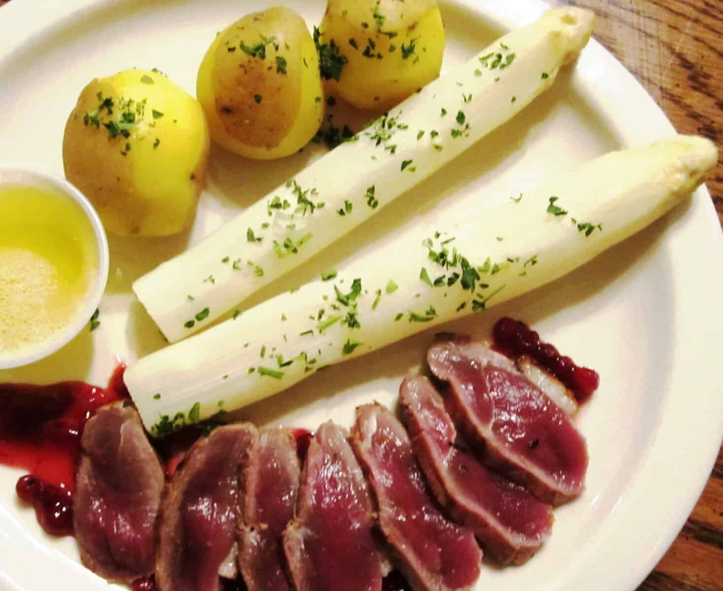 Seasonal white asparagus with sliced duck breast at Bavarian Grill in Plano, Texas