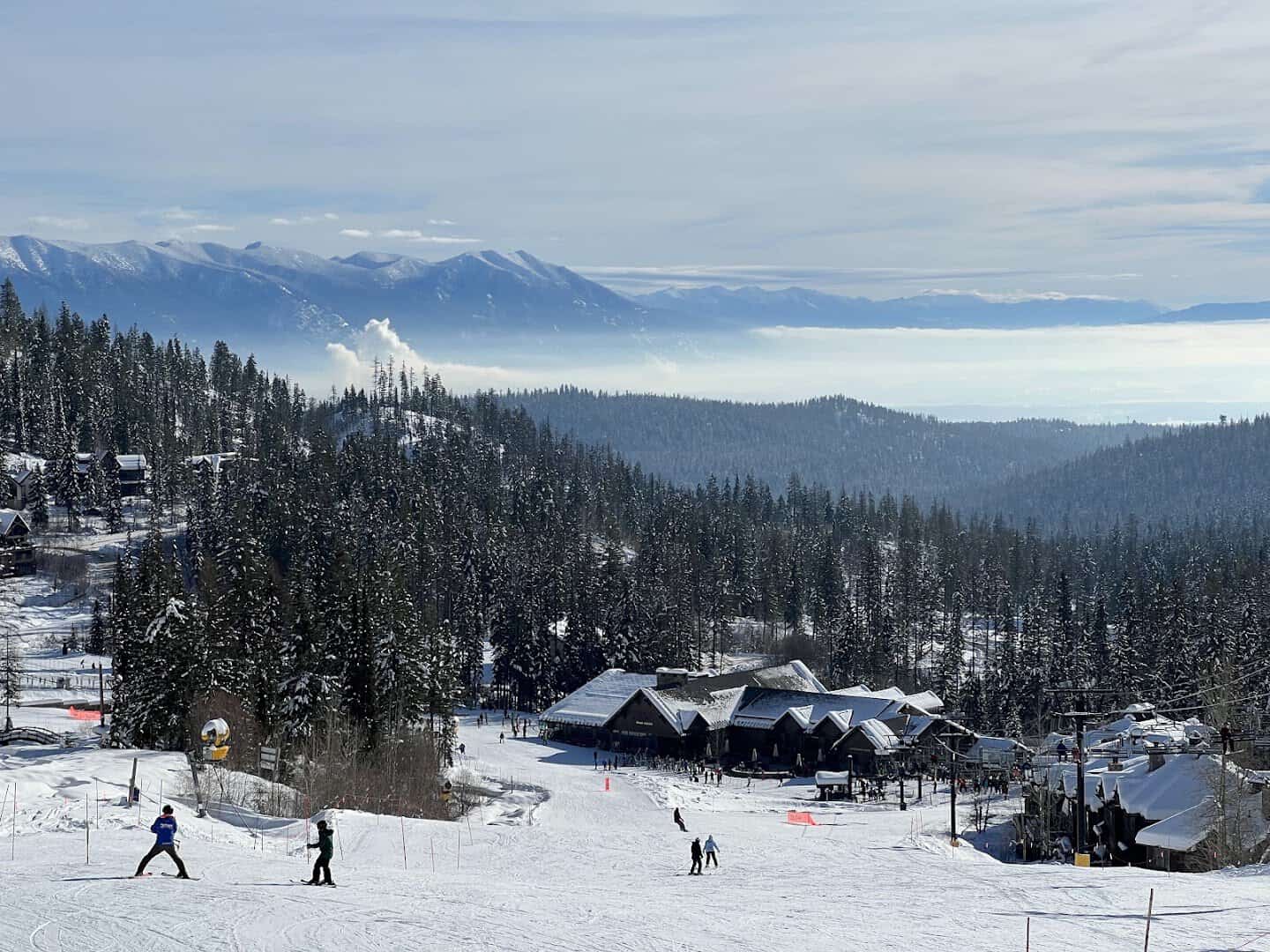 Snow-covered Whitefish Mountain Resort base lodge and snowy pines above the Flathead Valley, Whitefish, Montana