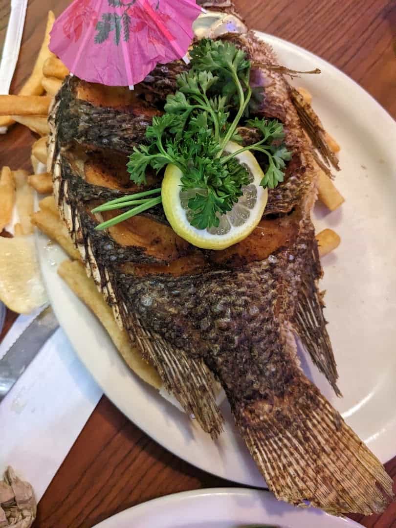 Whole fried fish with lemon and parsley at Baytown Seafood in Baytown, Texas