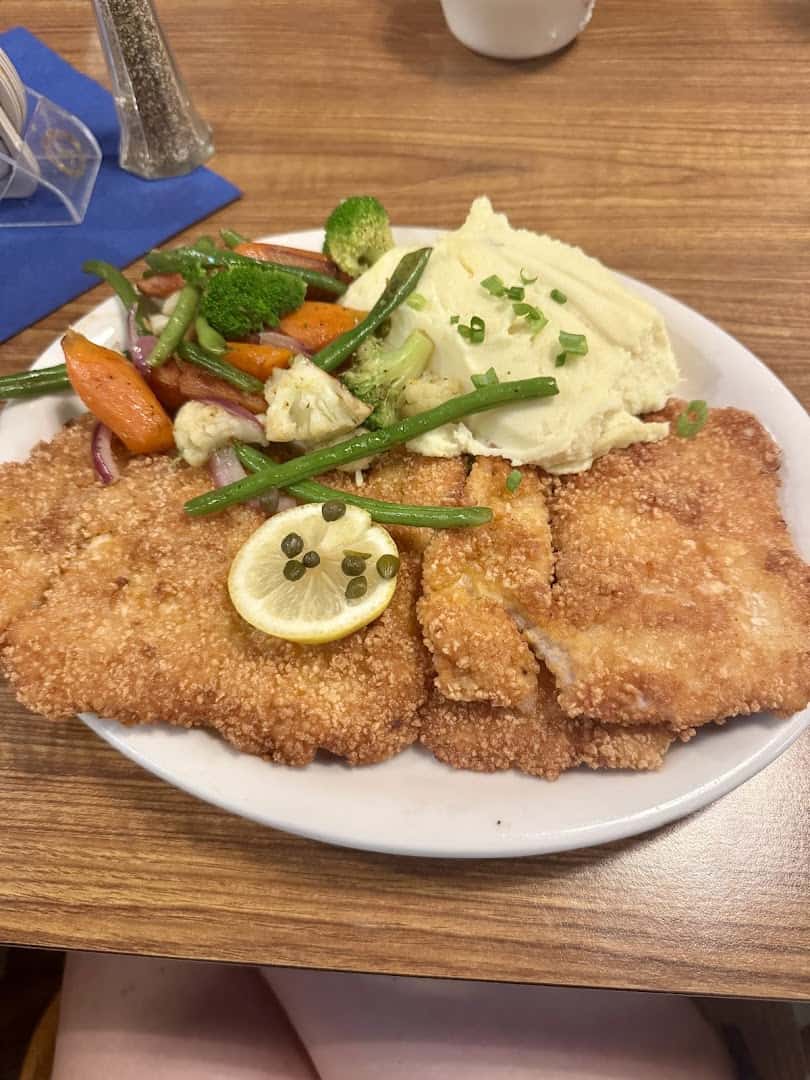 Large Wiener schnitzel with mashed potatoes and vegetables at Bavarian Grill in Plano, Texas