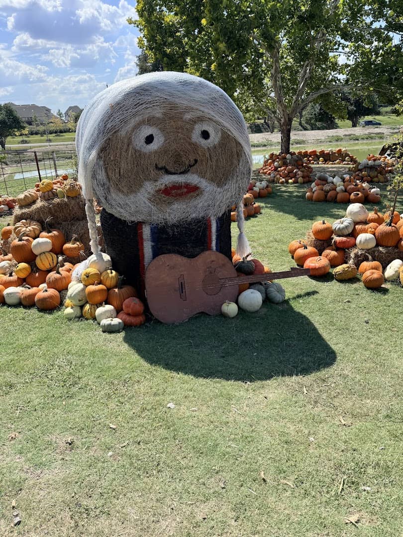 Hay bale Willie Nelson display with pumpkins at Huddin Homestead Fun Farm in Rockwall, Texas
