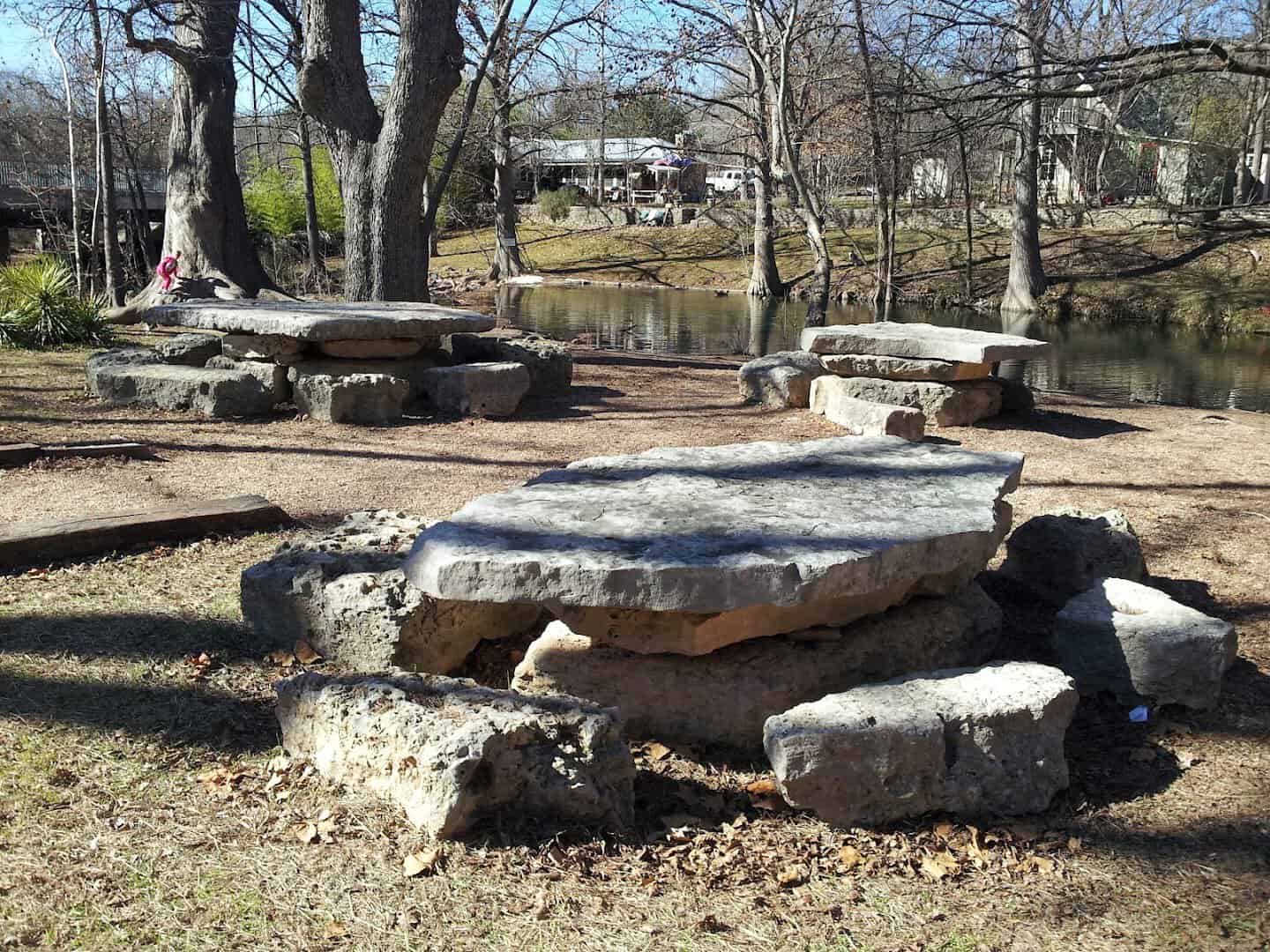 Cypress Creek and limestone tables at a riverside park in Wimberley, Texas