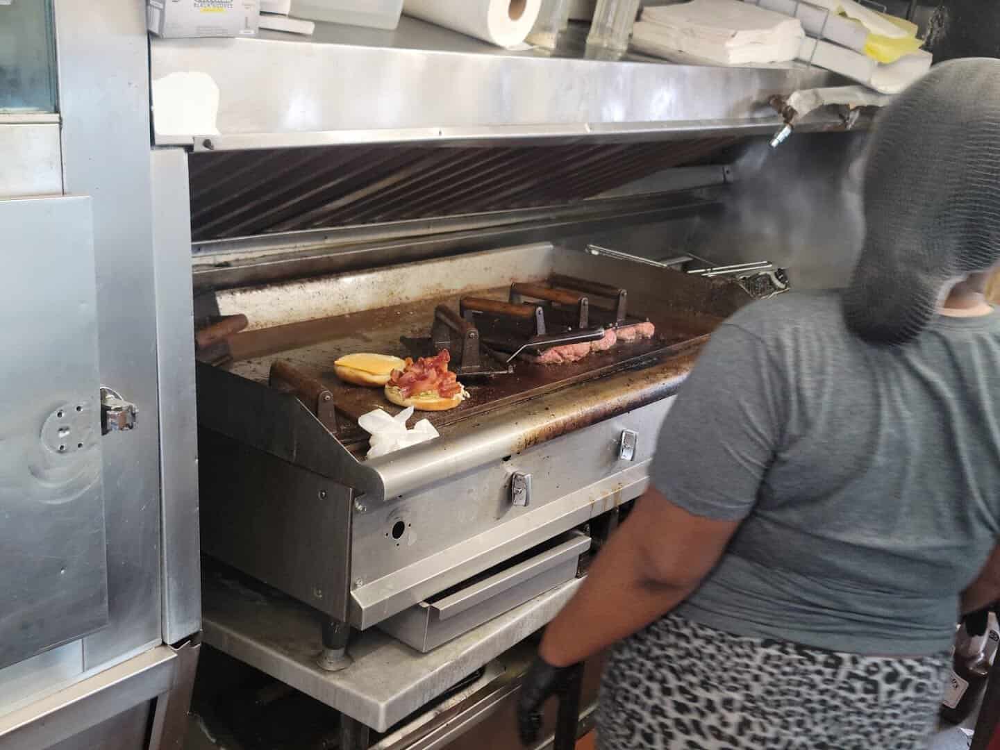 Patties pressed on the flat-top griddle at Wingfield's in Dallas
