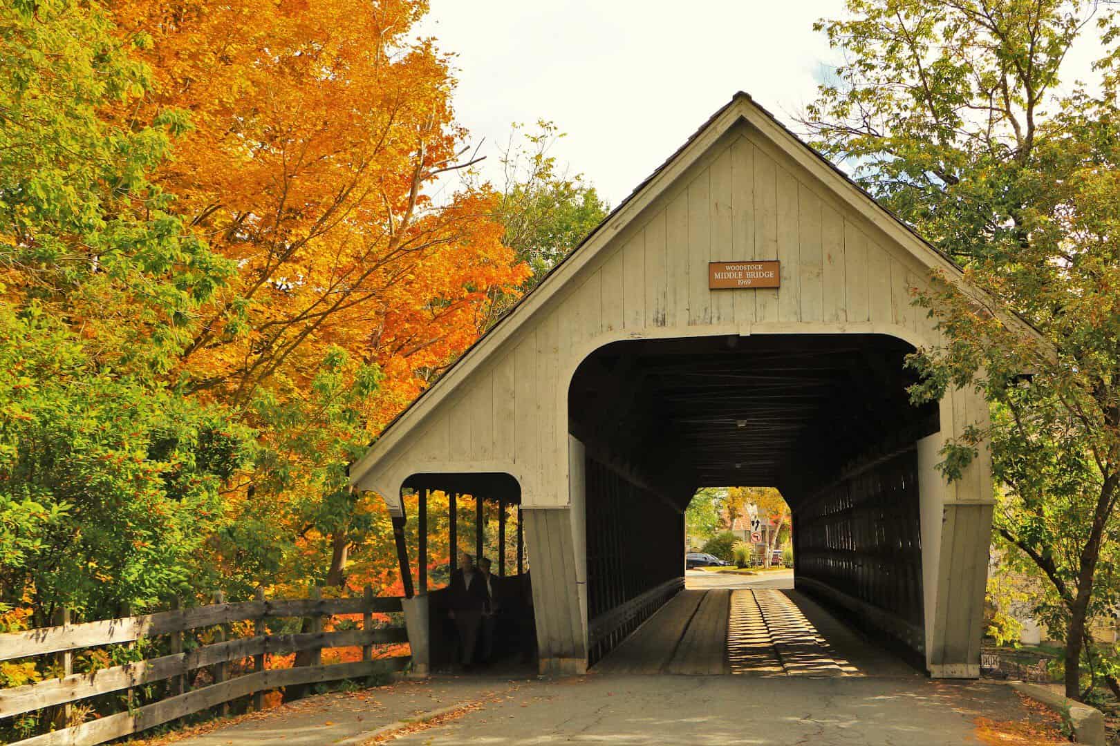 Woodstock's Middle Covered Bridge framed by bright fall foliage in Woodstock, Vermont
