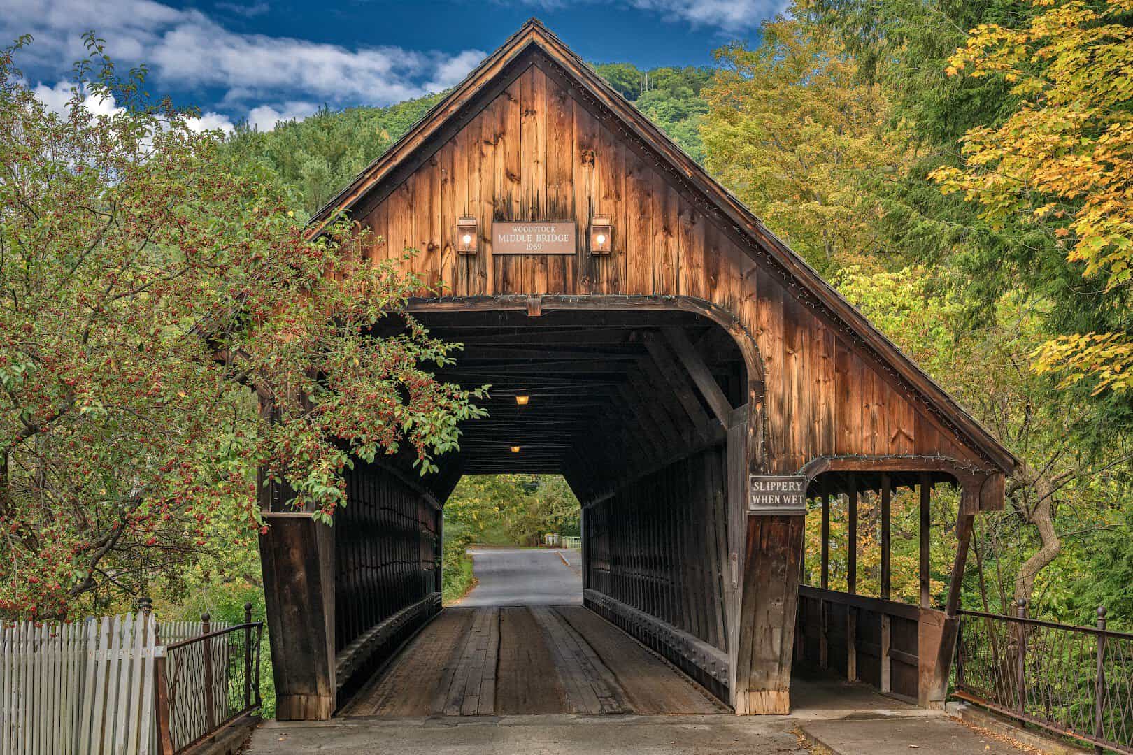 The Middle Covered Bridge framed by fall foliage in Woodstock, Vermont