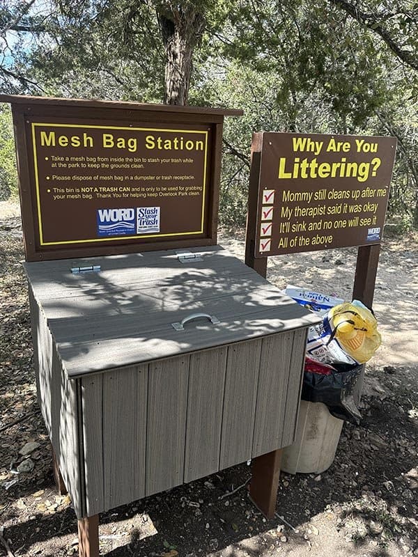 WORD mesh bag station and anti littering sign at a Canyon Lake park
