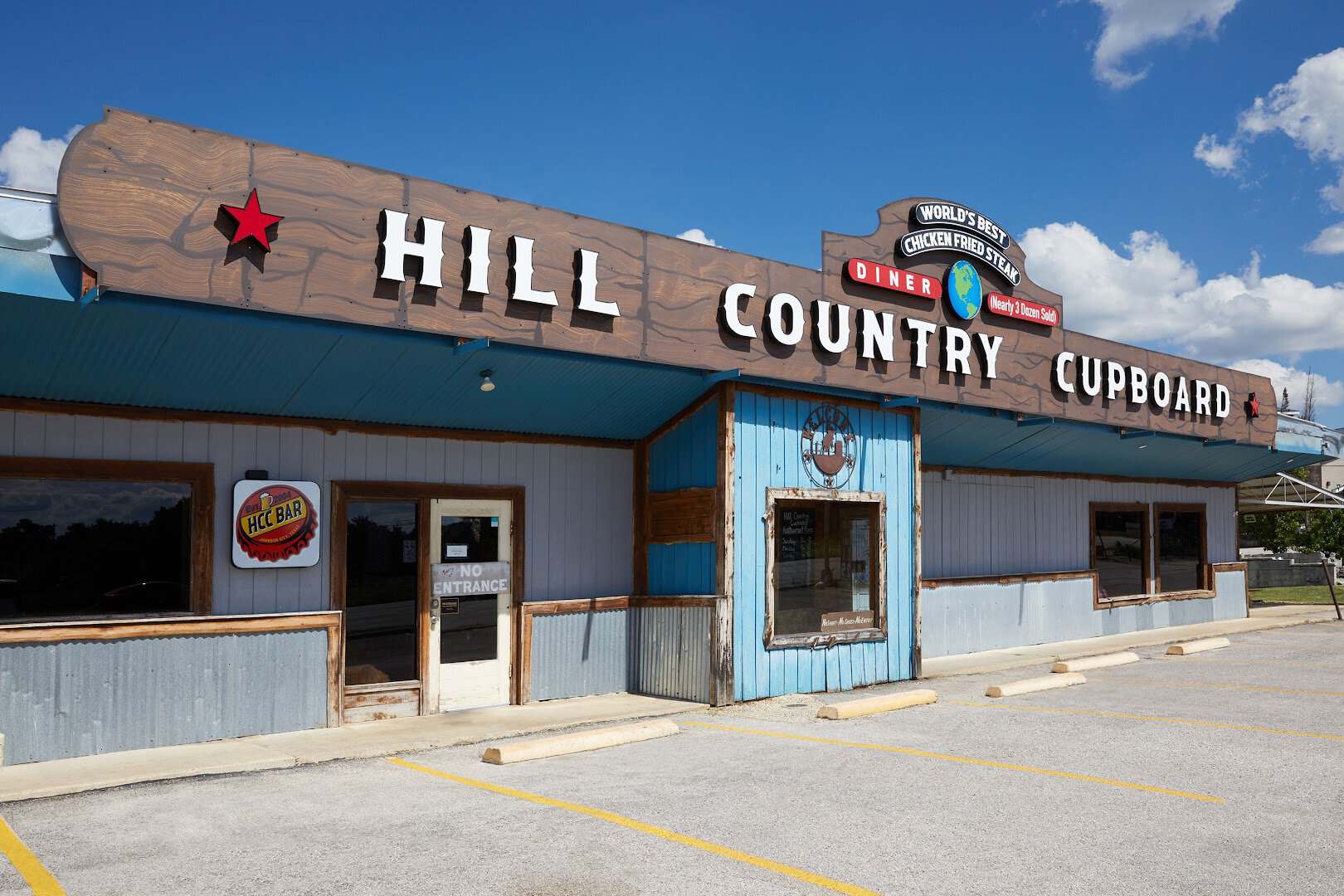 The Hill Country Cupboard roadside sign reading Worlds Best Chicken Fried Steak in Johnson City, Texas