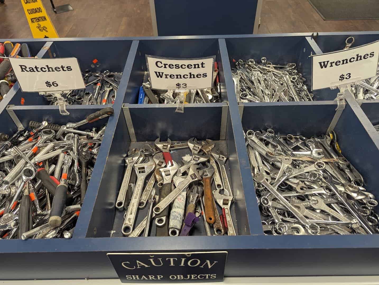 Bins of wrenches and ratchets with price tags at the State Surplus Store in Austin