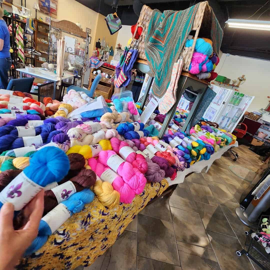Tables of colorful yarn fill the shop floor at Lone Star Yarn in Bedford, Texas