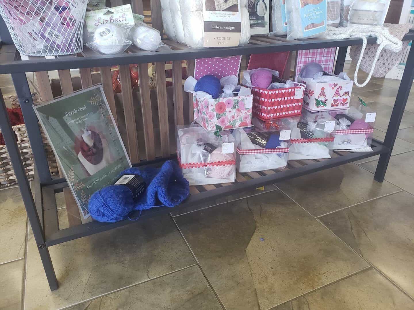A shelf of yarn gift sets and knitting kits at Lone Star Yarn in Bedford, Texas